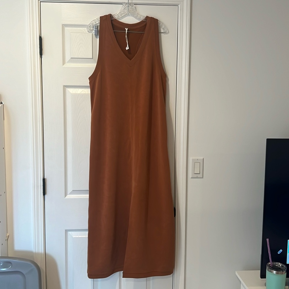 Super cute/flattering Lululemon size 12 dress with slit at bottom front.